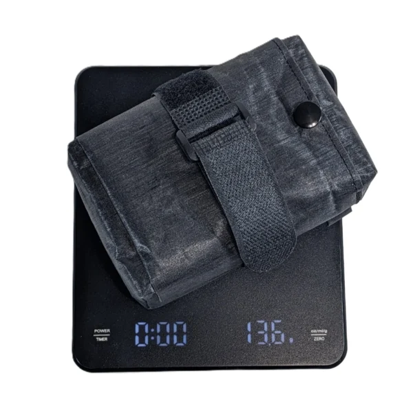 Bike saddle bag on a scale, weighing only 13 grams, showcasing its ultra-light design.