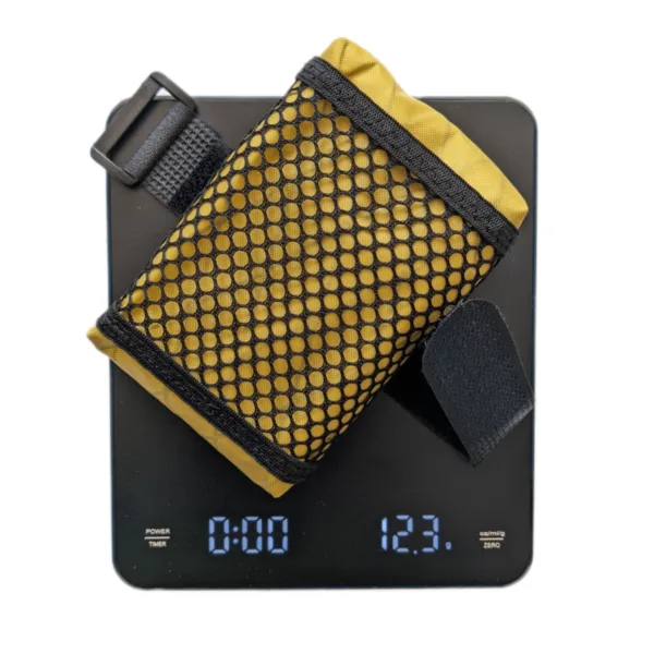 Handmade bike saddle bag placed on a scale showing a weight of 12 grams, demonstrating its ultra-light design.