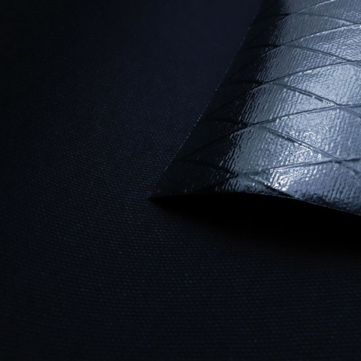 X-Pac X11 Lux Black fabric with plastic laminate backing, waterproof, durable, and wear-resistant.