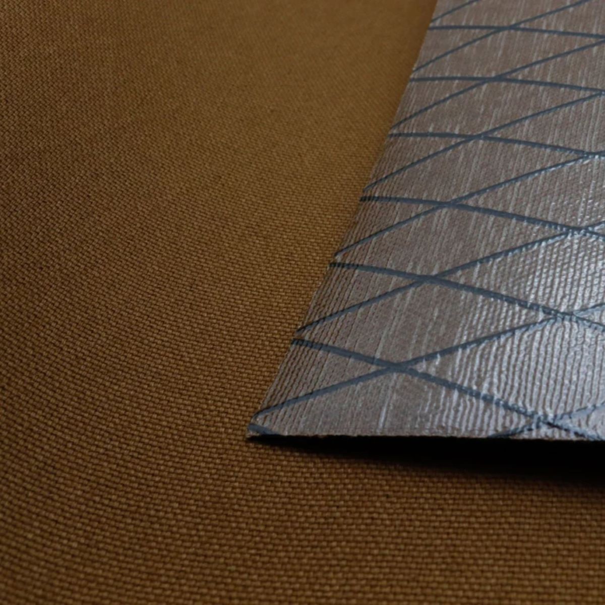 X-Pac X11 Mountain Brown fabric with plastic laminate backing, durable, waterproof, and abrasion-resistant.