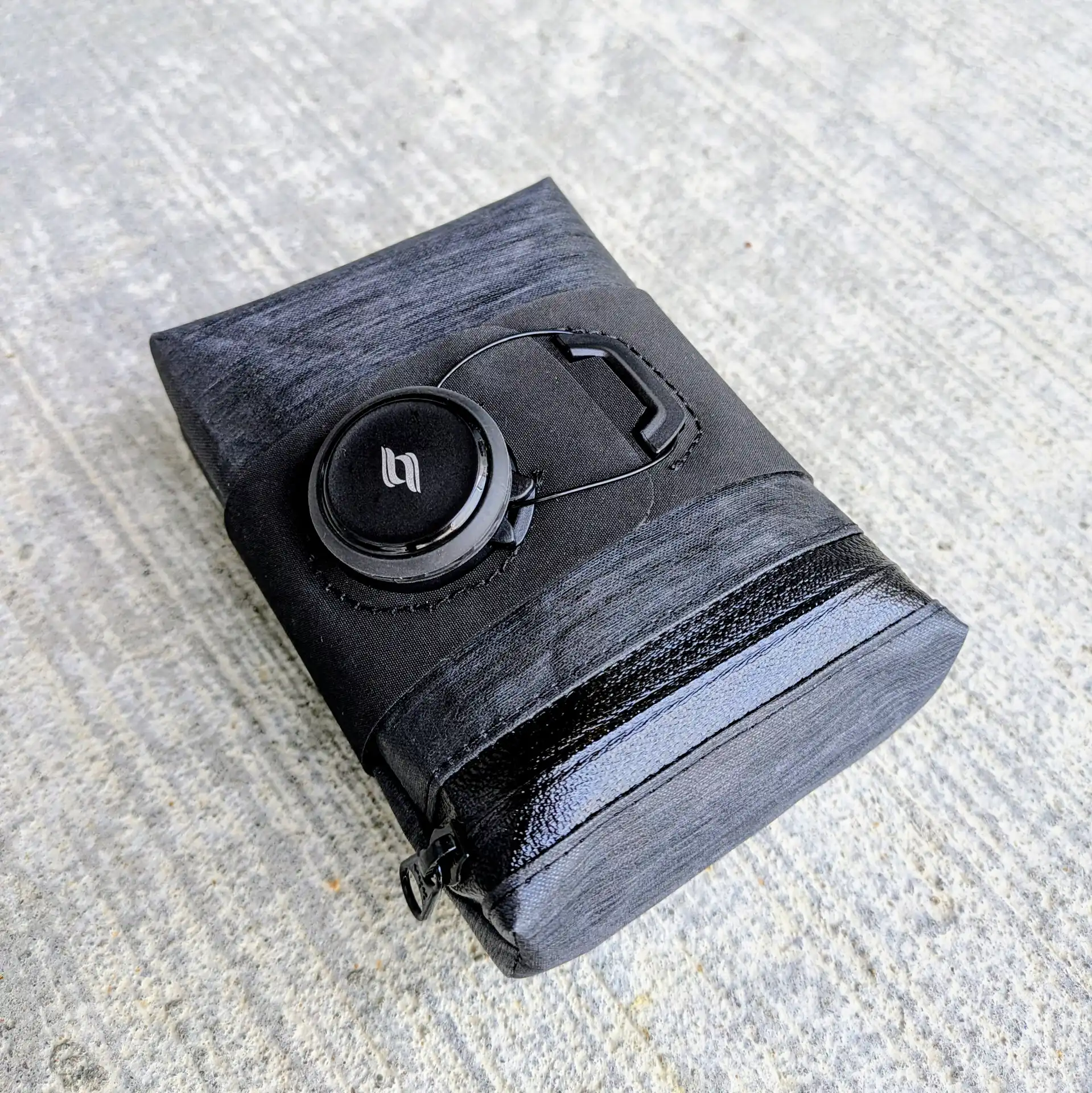 Compact bike saddle bag with BOA-style rotary tightening system and low-profile compact design.