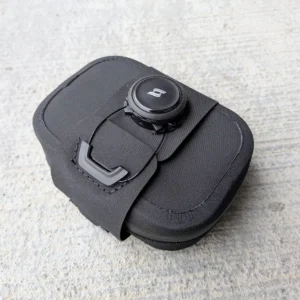 Small minimalist Hypalon bike saddle bag with BOA-style attachment mounted under a road bike saddle.