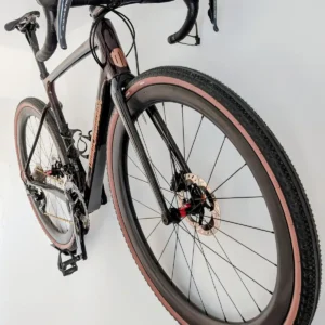 Wall-mounted carbon bike rack holding a road or gravel bike indoors.